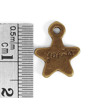 Dije Estrella con Mensaje “Sueña” Tono Bronce Envejecido 15x12x2mm | 9 uds