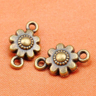 Conector Flor en Relieve con 8 Pétalos Redondeados y Botón Central Punteado Aleación Tono Bronce Envejecido 16x10mm | 5 uds