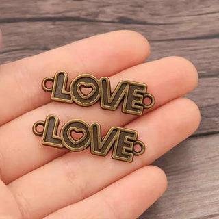 Conector Palabra LOVE en Relieve con Corazón Calado Aleación Tono Bronce Envejecido 36x10x1.5mm | 4 uds