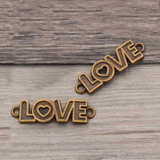 Conector Palabra LOVE en Relieve con Corazón Calado Aleación Tono Bronce Envejecido 36x10x1.5mm | 4 uds