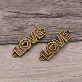 Conector Palabra LOVE en Relieve con Corazón Calado Aleación Tono Bronce Envejecido 36x10x1.5mm | 4 uds