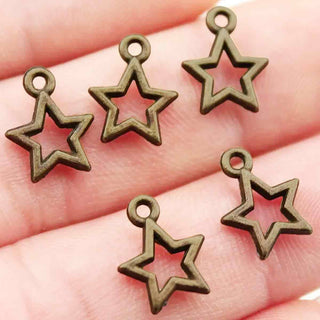 Dije Estrella Estilo Tibetano Tono Bronce Envejecido 14.5x12x1mm | 14 uds