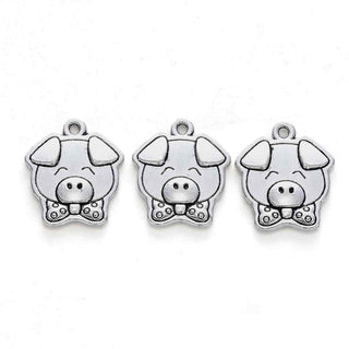 Dije Cerdo Carita Feliz con Corbatín Tono Plata Envejecida 16x13mm | 5 uds