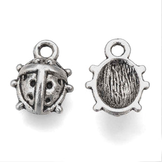 Dije Mariquita con Caparazón de Puntos y Reverso Cóncavo Tono Plata Envejecida 11x8.5mm | 12 uds