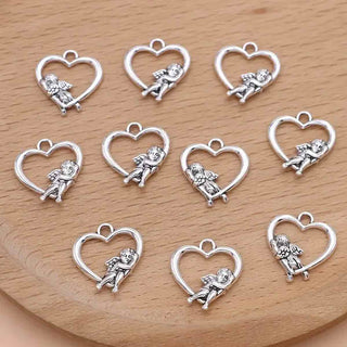 Dije Corazón con Ángel Estilo Tibetano Tono Plata Envejecida 19.5x18x3mm | 7 uds
