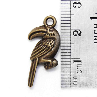 Dije Tucán Estilo Tibetano de Aleación Tono Bronce Envejecido 26x13x3mm | 5 uds