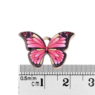 Colgantes de aleación en forma de mariposas rosadas esmaltadas.