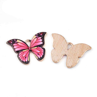 Colgantes de aleación en forma de mariposas rosadas esmaltadas.
