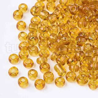 Mostacilla 8/0. Cuentas de vidrio redondeadas, color transparente, varios tonos para seleccionar,, cerca de 3 mm.